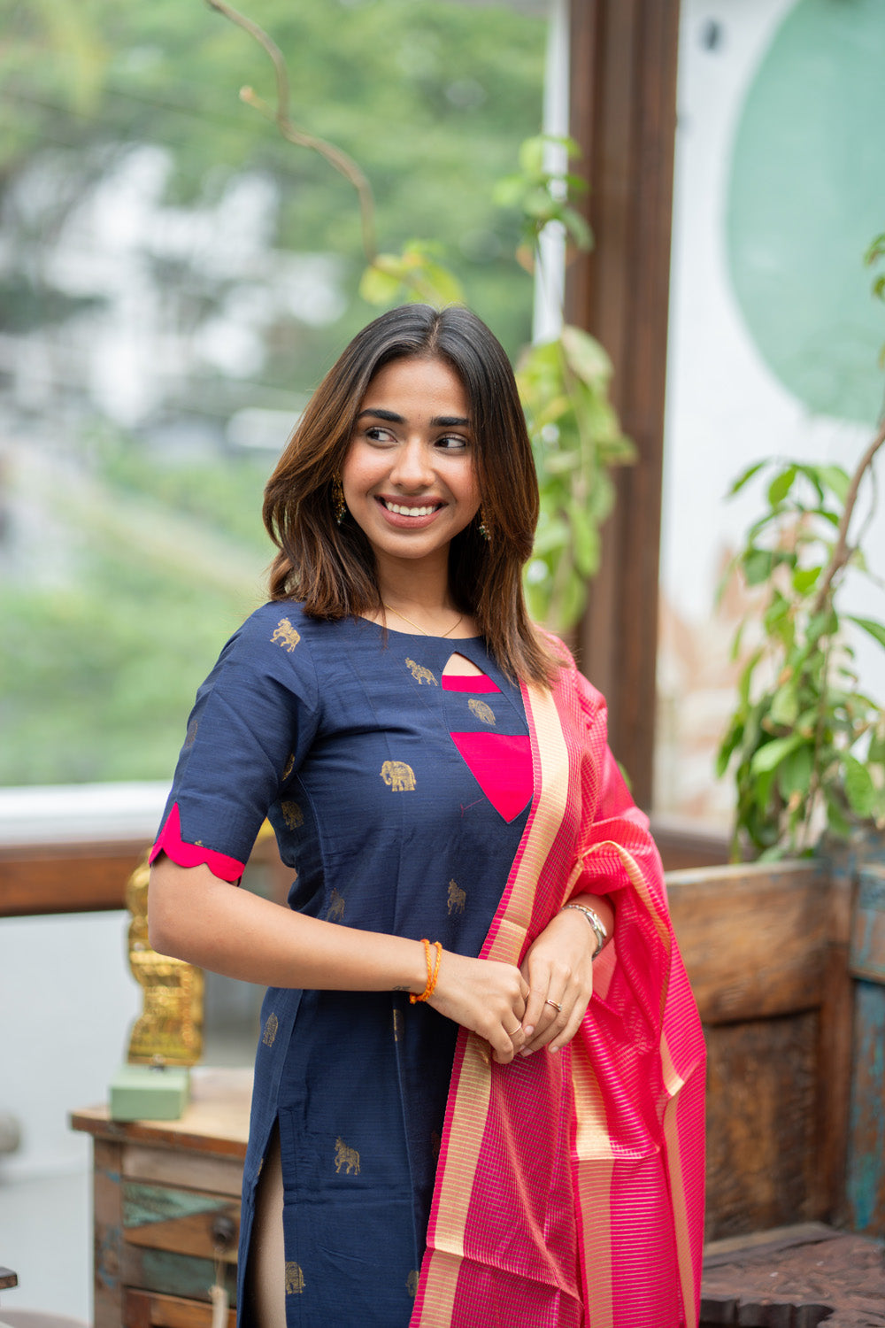 Dark Blue Raw Silk Kurti with Golden Elephant & Horse motifs Paired with Rani Pink Zari Checks Dupatta(Neck & sleeve patched with Rani pink Silk fabric)