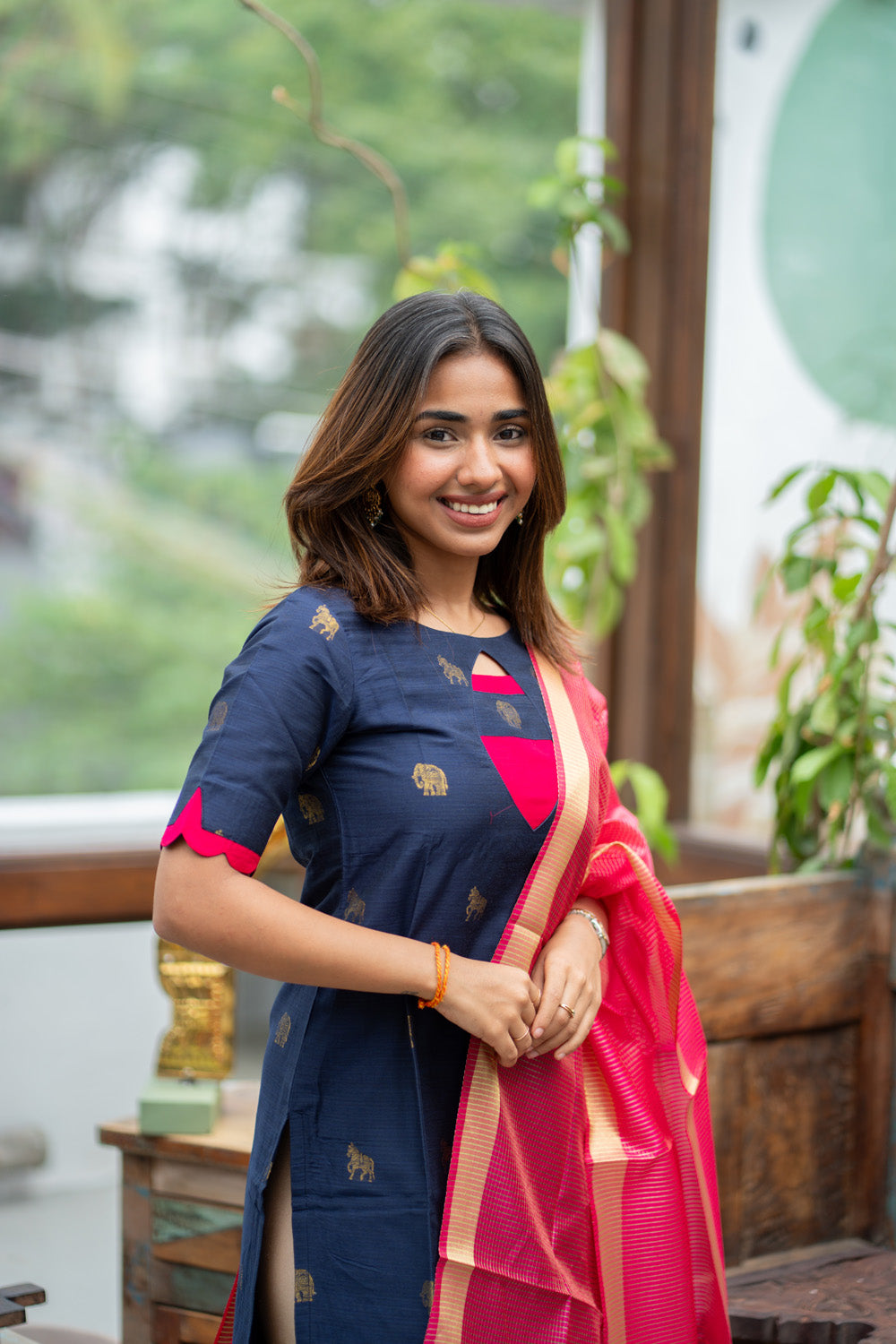 Dark Blue Raw Silk Kurti with Golden Elephant & Horse motifs Paired with Rani Pink Zari Checks Dupatta(Neck & sleeve patched with Rani pink Silk fabric)